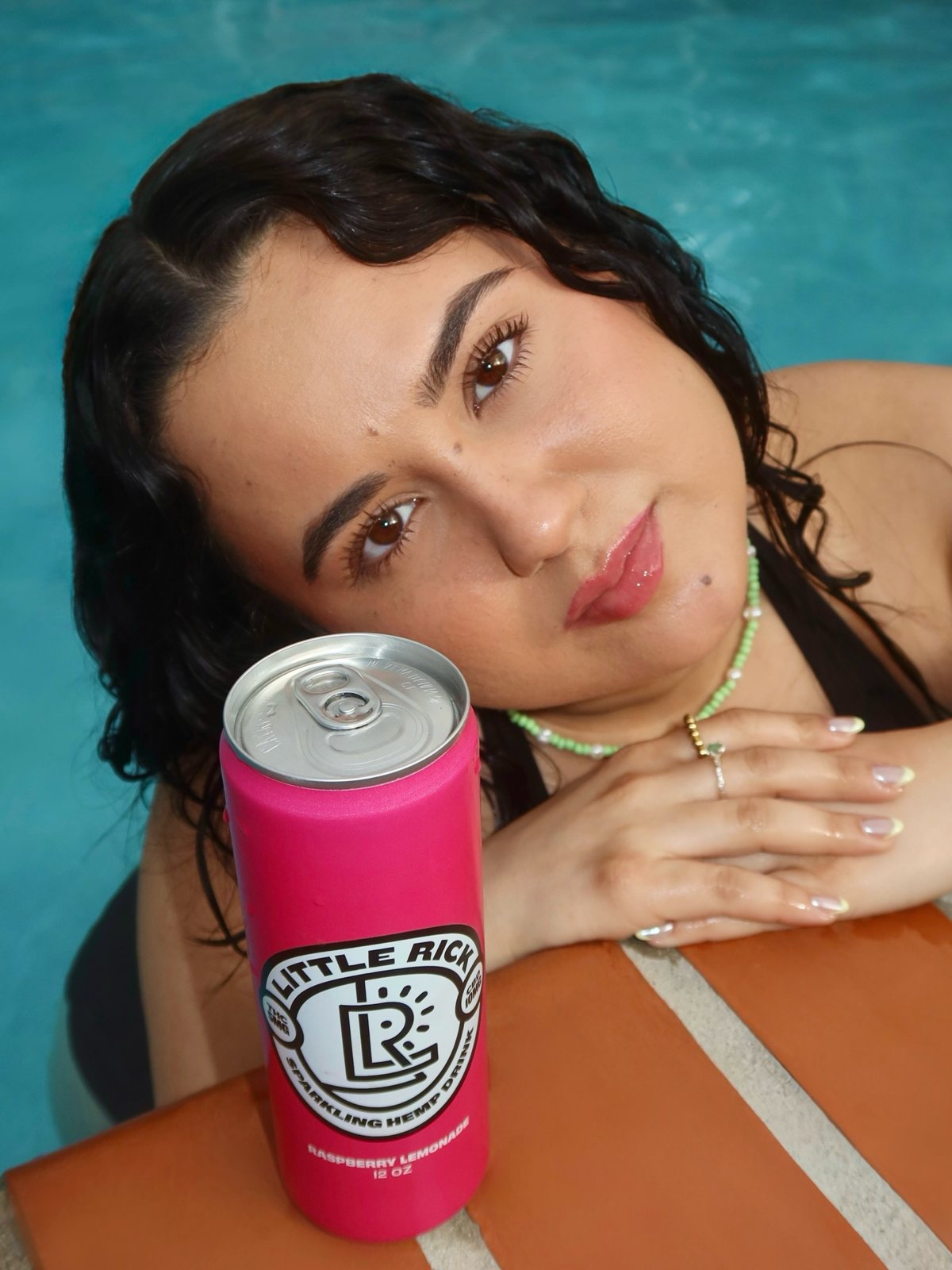 Poolside with a can of Little Rick Raspberry Lemonade